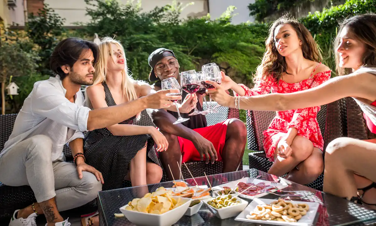 Un groupe de personne qui lève leur verre avec des amuse-bouches sur la table